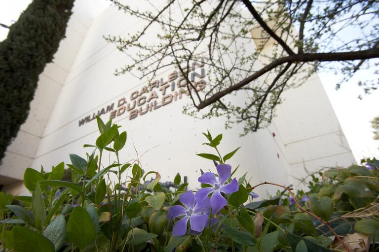 Carlson Education Building with spring flowers in the foreground