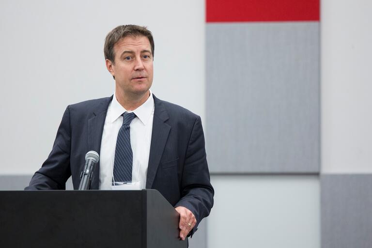 Bo Bernhard speaks at a podium