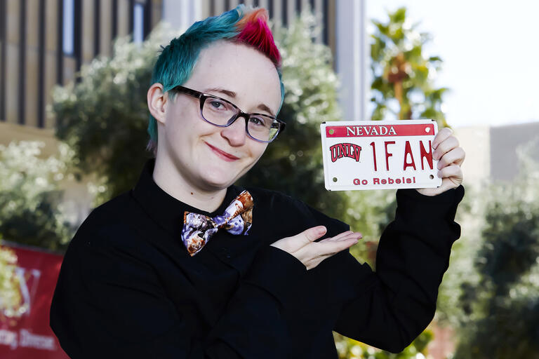 Person holding UNLV fan license plate