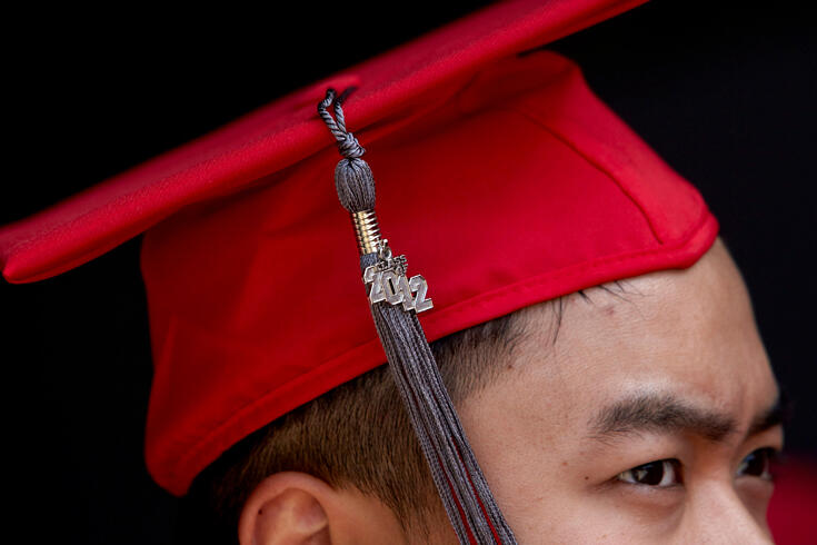 Close up side view of a graduate with a graduate hat on.