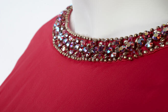 Top trim of a dress. Trim contains sparking rhinestones.