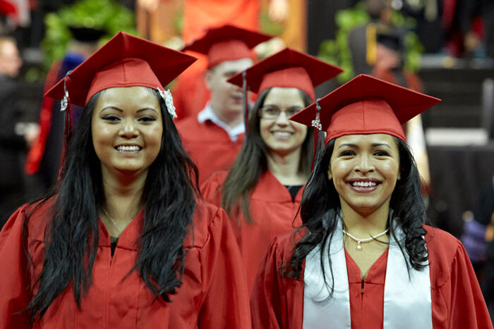 Female graduates standing in line during commencement.