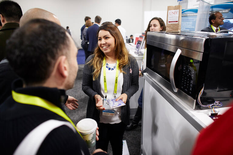Student Michelle Mata works at a Consumer Electronics Show booth