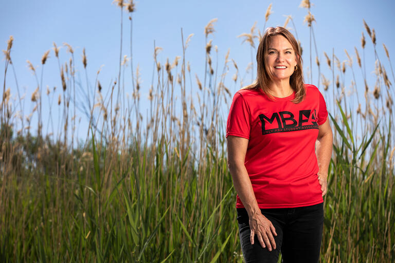 Lisa Davis standing in tall grass at the Wetlands.