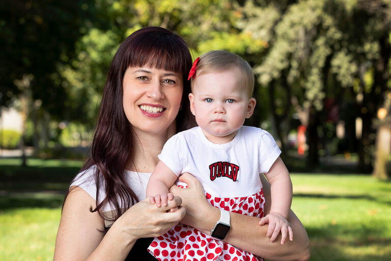 Janine Barrett poses with her 10-month-old daughter, Makenzie on campus.