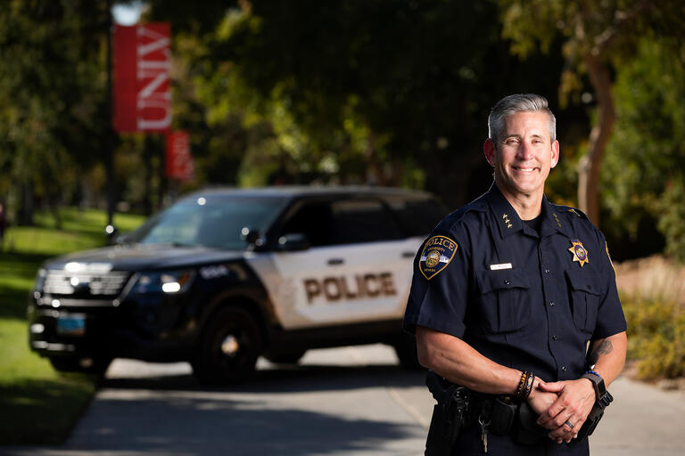 Police Services Assistant Chief Tod Miller poses in front of his cruiser on UNLV's campus.