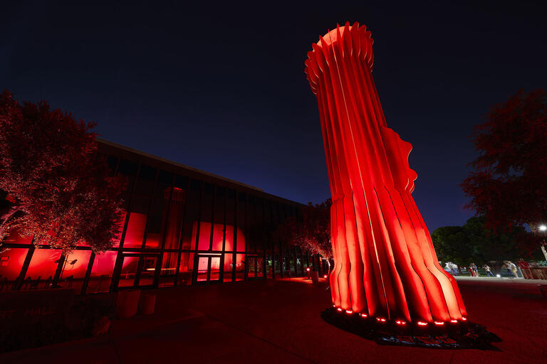 UNLV's Flashlight sculpture with red lighting shining outwards of it