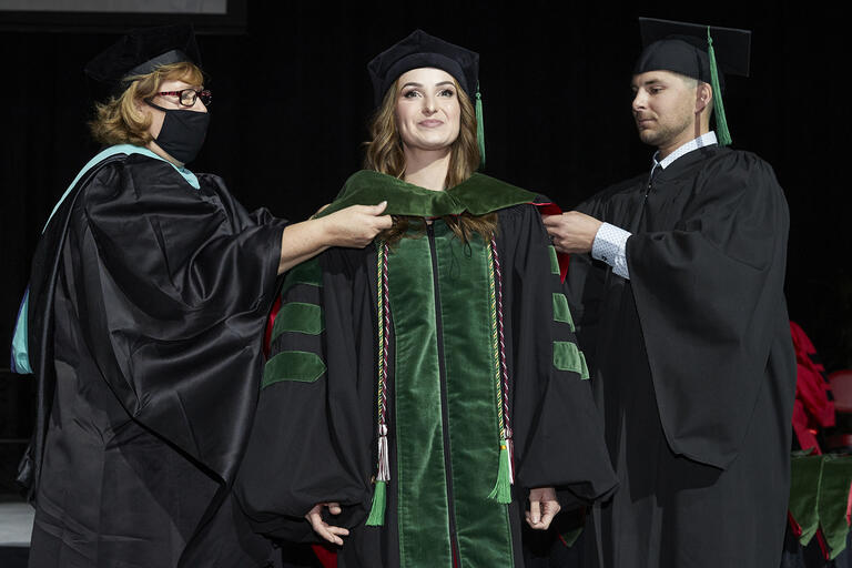 woman in doctoral hood ceremony