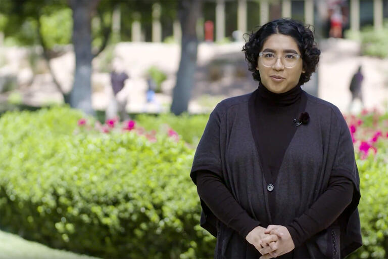 woman outside by rose garden