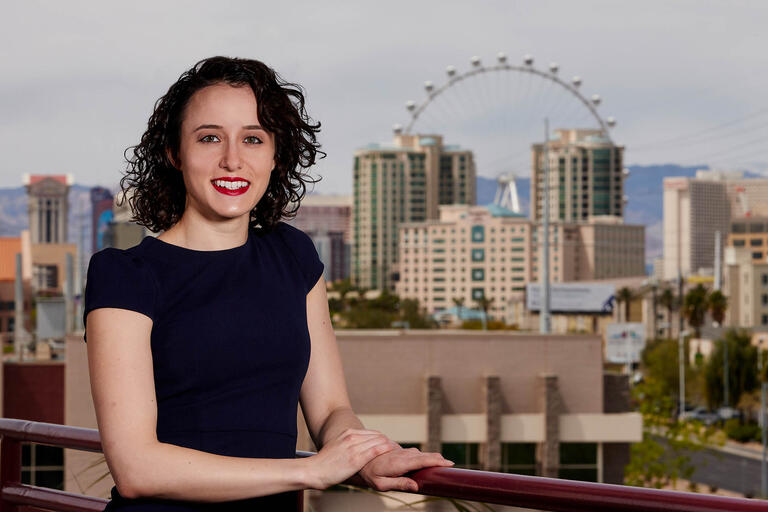A portrait of Shekinah Hoffman with a portion of the Las Vegas skyline, including the High Roller, in the background.