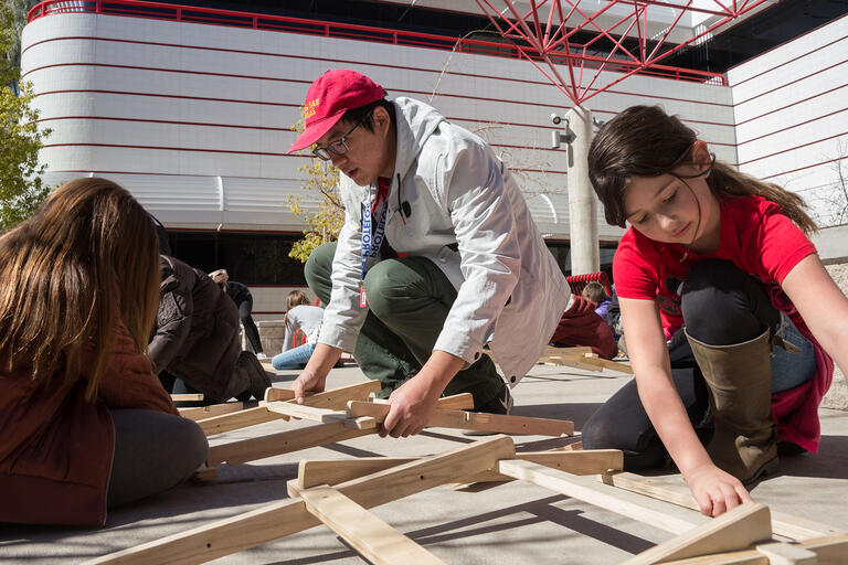 Kids building an arch bridge