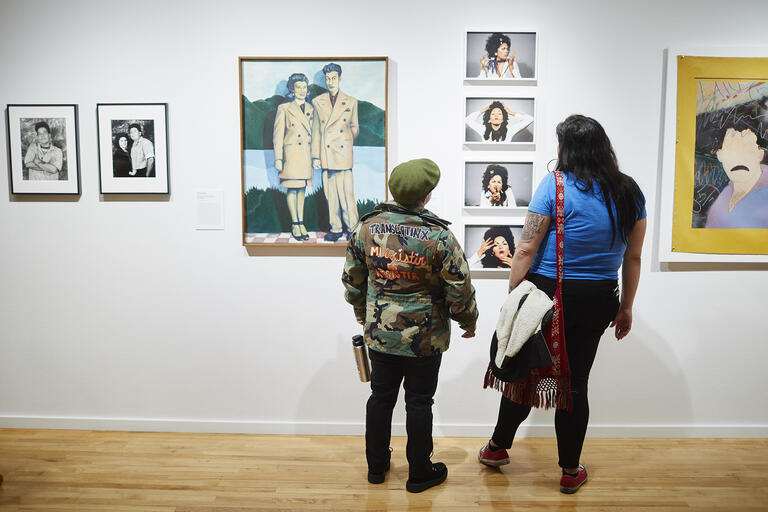 Two women viewing artwork
