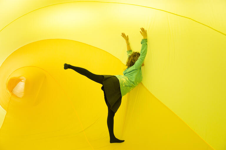 female dancer surrounded by yellow material