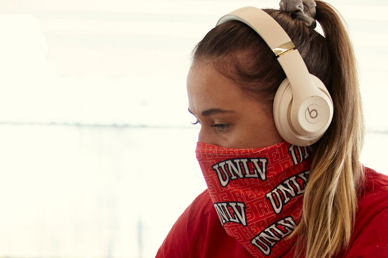 A woman in a UNLV mask