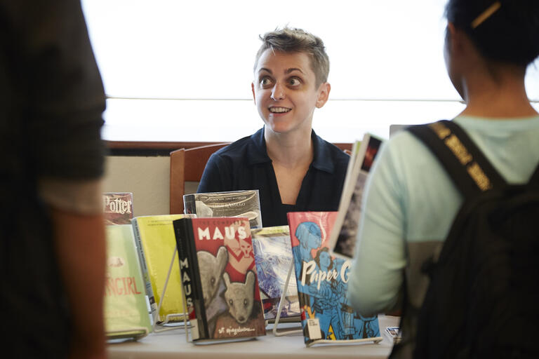 woman at display of children's books