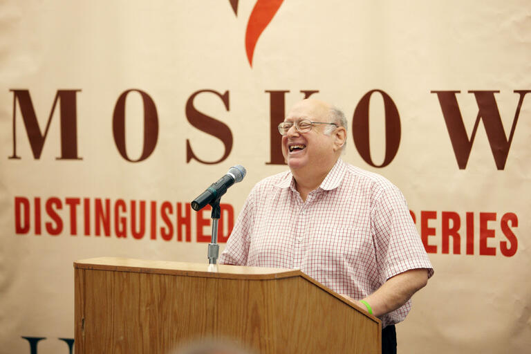 man speaking at podium