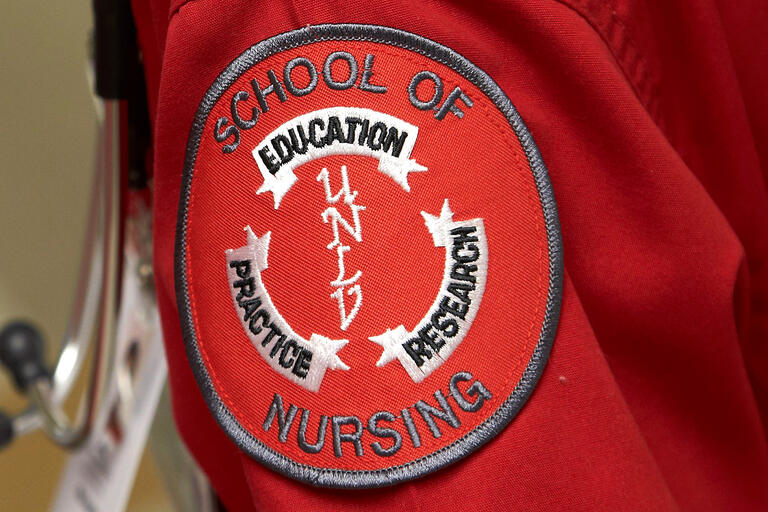 A red patch shows the emblem for the UNLV School of Nursing