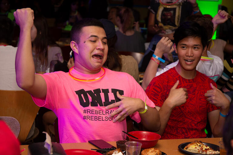 A student pumps a fist in celebration.