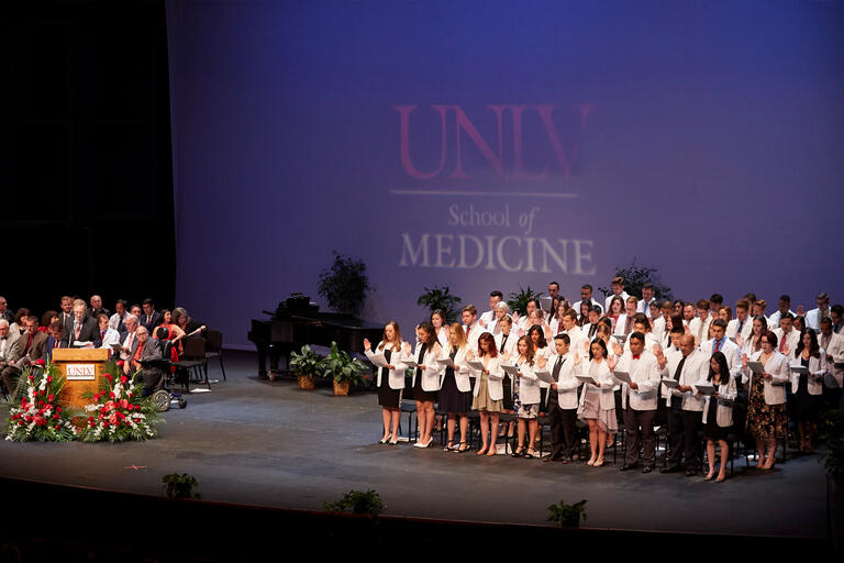 A group of students stand on a stage.