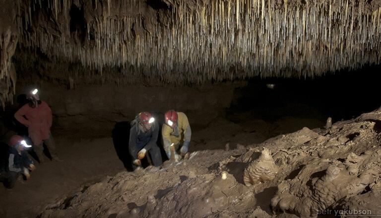 Jonathan Baker and colleagues examine stalagmite in a cave
