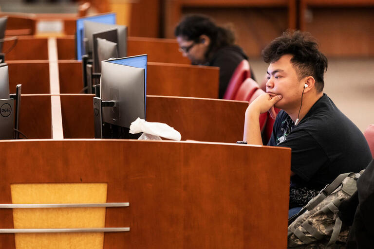 student seated at a computer terminal in lied library