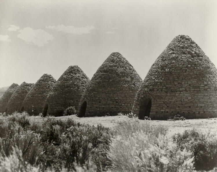 Historic site of charcoal ovens in a field.