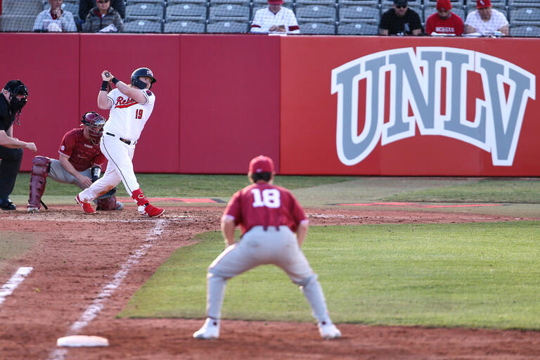 The first baseman readies to make a play as a UNLV batter takes a swing
