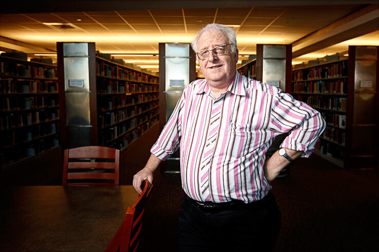 Professor Eugene Moehring standing in the library
