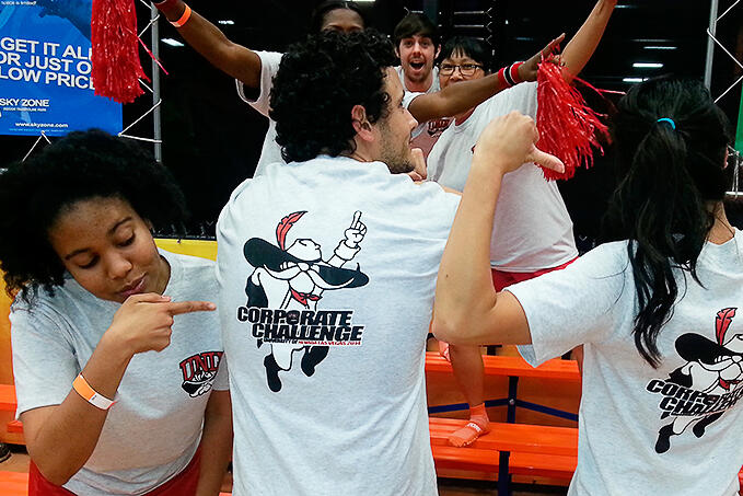 Team UNLV members showing off their Corporate Challenge shirts.