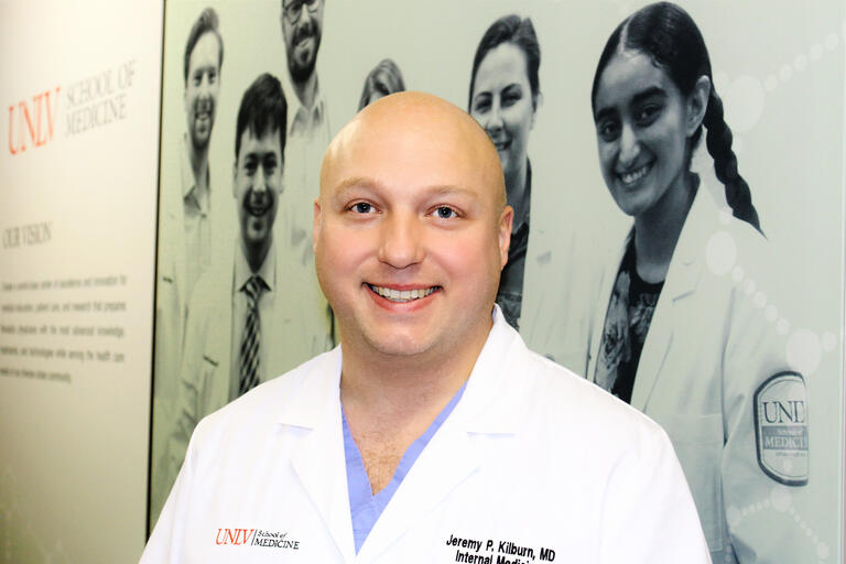 Portrait of Dr. Jeremy Kilbun wearing a white medical coat