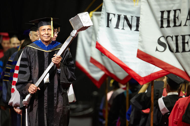Sadanand Verma carries the university mace during commencement
