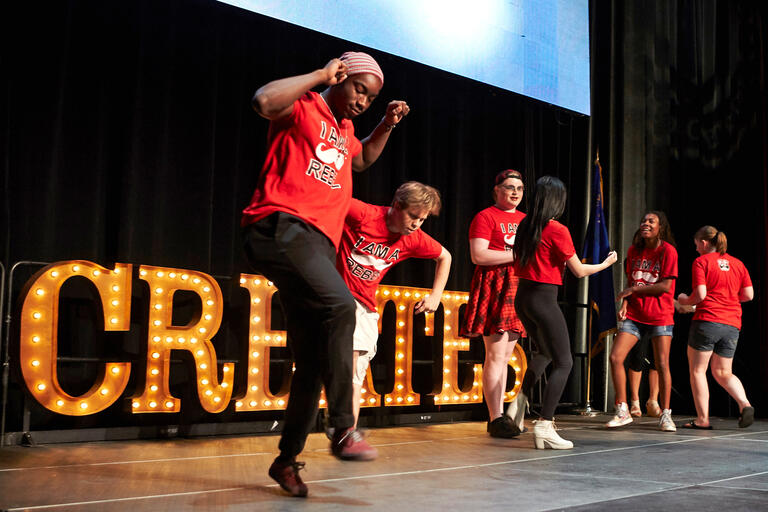 Students peform a dance on stage