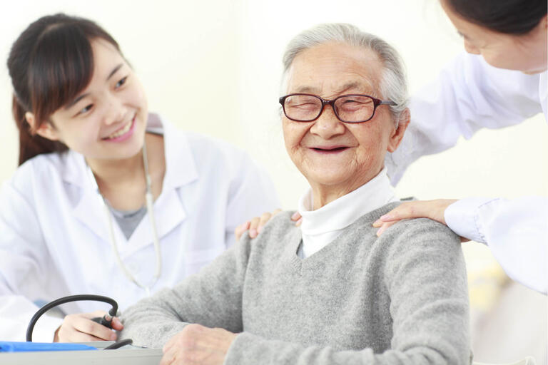 Asian elderly man with two medical providers