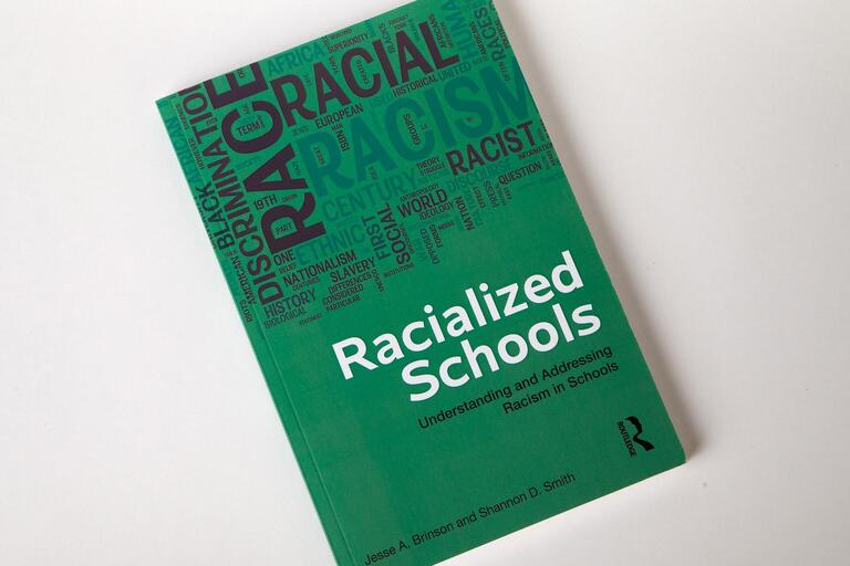 book cover for Racialized Schools
