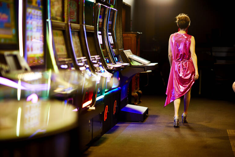 woman walking away from slot machines