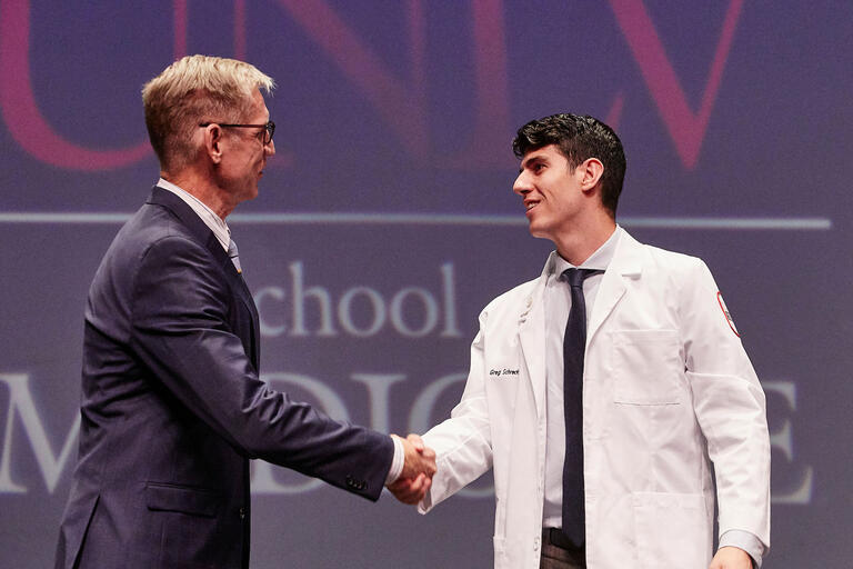 Dr. Stephen Dahlem shakes hands with student Gregory Schreck.