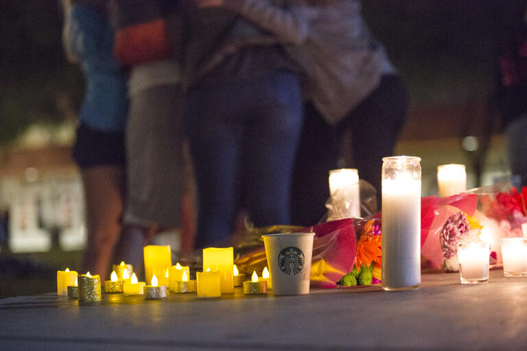 candles in forground, group hugging in background