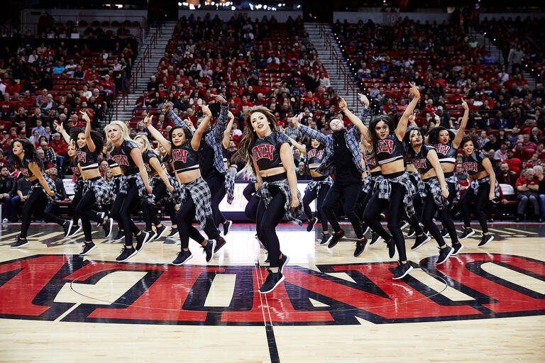 The Rebel Girls & Company perform during a basketball game.