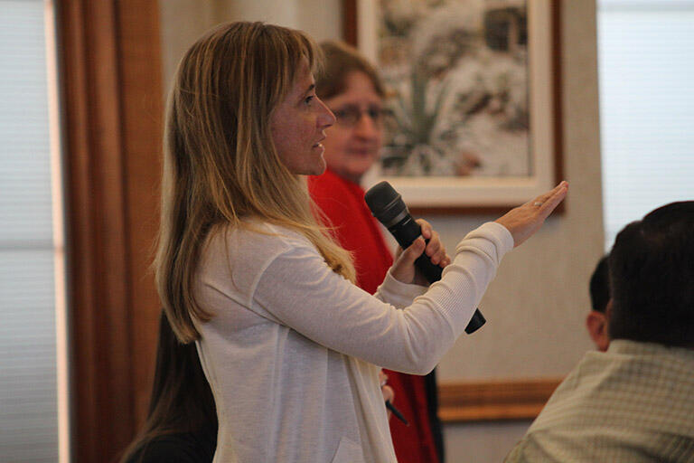 Woman speaking through microphone