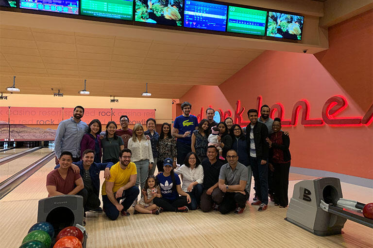 Group of people smiling in a bowling alley