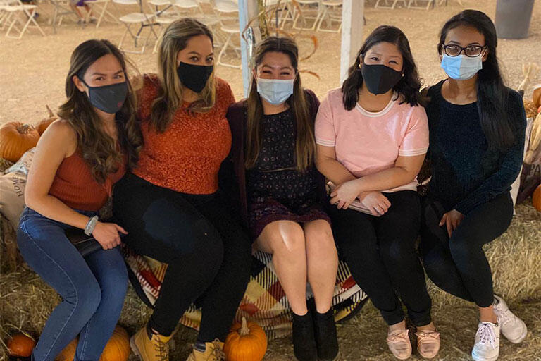 Internal Medicine residents smiling while wearing a mask