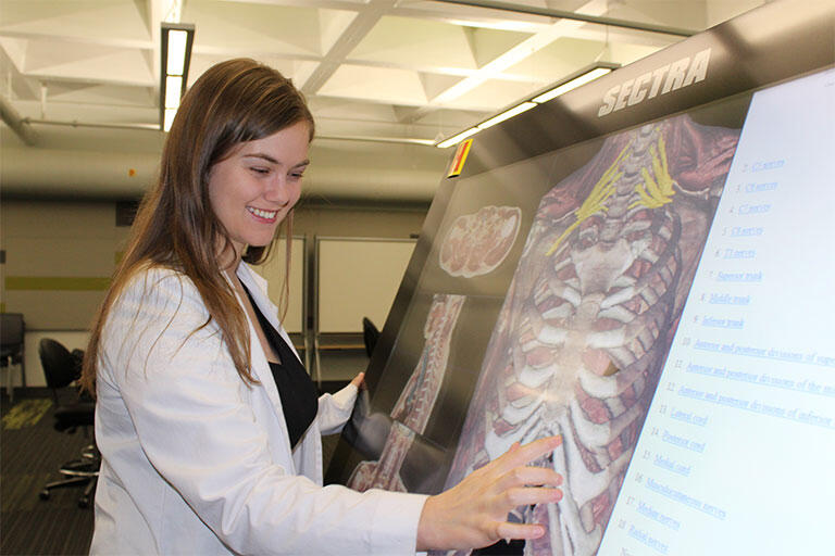 Crystal Dickson, a UNLV School of Medicine Charter Class graduate student, interacting with a screen