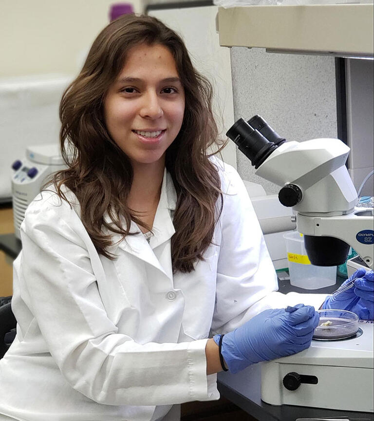 Female student smiling in the lab