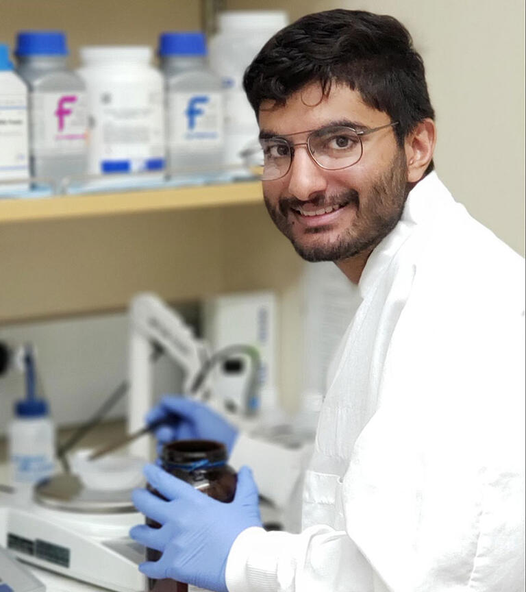 Male student smiling in the lab