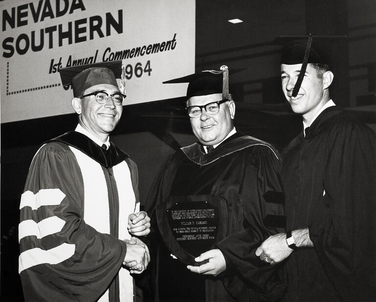 students and administrators standing at UNLV's first commencement in 1964
