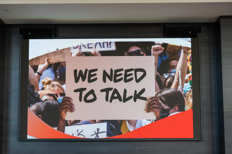 We Need to Talk sign on TV screen