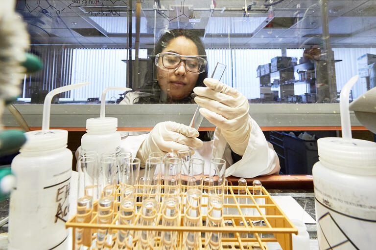 Student researcher Citlally Lopez works in a chemistry lab