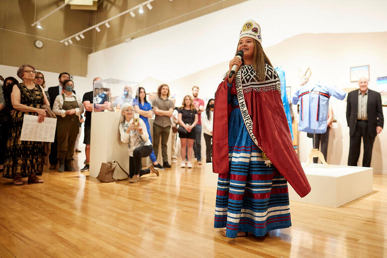 woman in formal indigenous clothing speaking