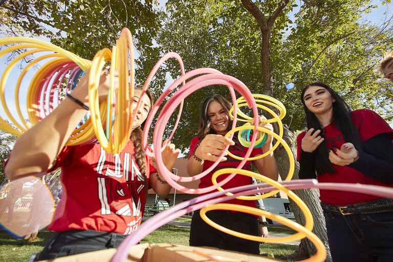 students with large colorful spirals