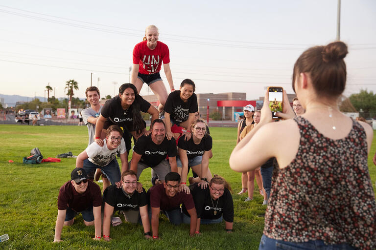 A person taking a picture on their phone of a group pyramid